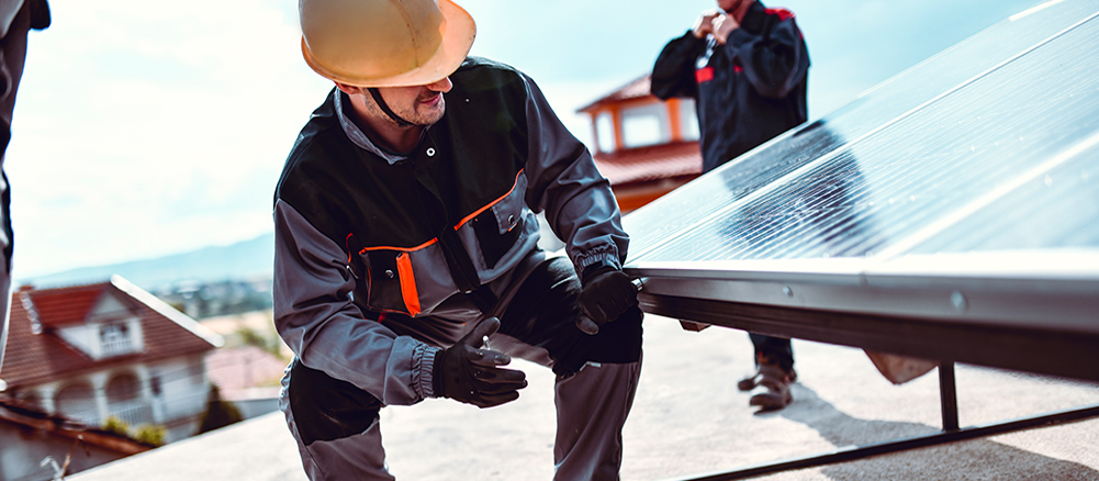 Flat roofing contractor installing new roof for industrial building